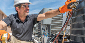 Man servicing exterior HVAC equipment