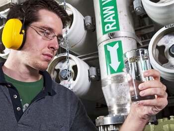 Service man inspecting a water sample