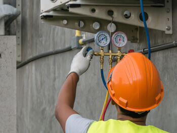 Man servicing equipment at a commercial site